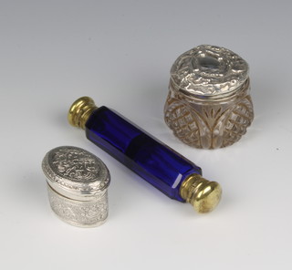 An Edwardian repousse silver toilet jar with lid, Birmingham 1906, an oval pill box and a double ended glass salt