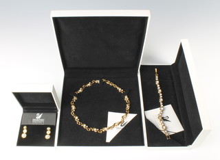 A Swarovski crystal necklace, bracelet and ear drops, all boxed