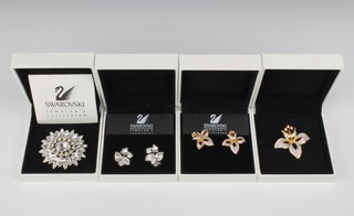 A Swarovski crystal brooch and matching earrings and a floral brooch, all boxed
