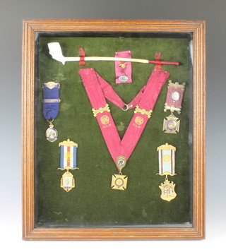 A display case containing 5 buffalo jewels and a pipe