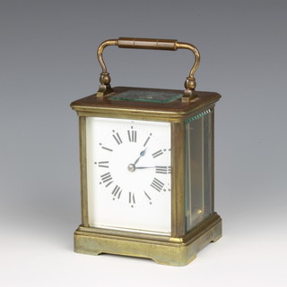 A 19th Century French 8 day carriage timepiece with enamelled dial and roman numerals contained in a gilt metal case 4"h x 3 1/2"w x 3"d