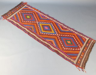 A multicoloured Suzni Kilim runner with 3 stylised diamonds to the centre within a multi row border 84" x 27"  