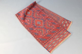 A red and blue ground Meshwani runner with 4 diamonds to the centre within a multi-row border 86 1/2" x 24" 
