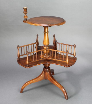 A Victorian circular walnut revolving sewing table fitted a pierced gallery with adjustable candle stand, raised on pillar and tripod supports 30"h x 15" diam.  