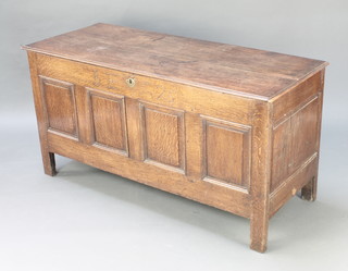 An 18th Century oak coffer of panelled construction, the interior fitted a candle box, the front marked B E 1725 27"h x 54"w x 22"d 
