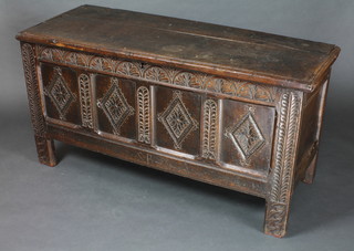 A 19th Century oak coffer of carved panelled construction, the interior fitted a candle box 30"h x 58"w x 22"d
