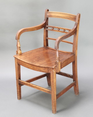 A Georgian mahogany bar back carver chair with solid saddle seat, raised on square tapering supports with box frame stretcher 