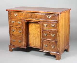 An 18th Century style dressing table fitted 1 long and 6 short drawers with cupboard to the pedestal enclosed by a panelled door, raised on bracket feet 29"h x 38 1/2"w x 19"d (this piece is made up)
