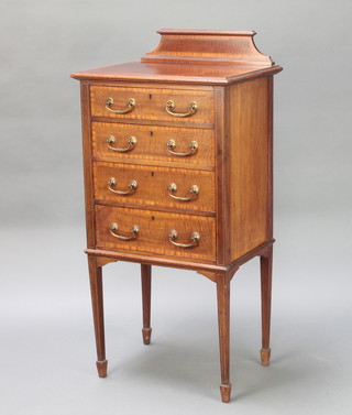 An Edwardian mahogany music cabinet inlaid ebonised and satinwood stringing, with raised back and fitted 4 drawers, raised on square tapered supports 41 1/2" x 20" x 15" 