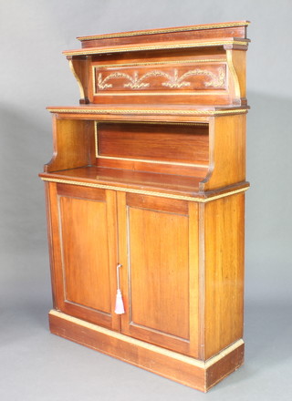 A walnut chiffonier the raised back fitted 2 shelves above a recess with cupboard enclosed by panelled doors and gilt mounts 64"h x 42"w x 14"d