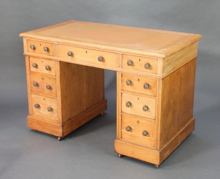 A Victorian bleached oak kneehole desk fitted 1 long and 8 short drawers raised on a platform base 27 1/2"h x 42'w x 23"d