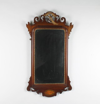 A Chippendale style arched bevelled plate wall mirror contained in mahogany frame surmounted by a figure of a bird 36"h x 19 1/2"w 