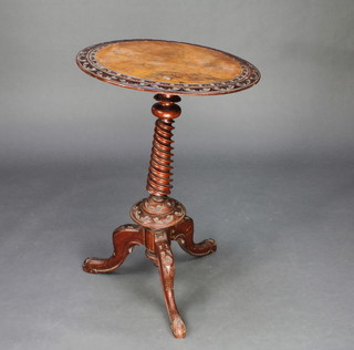 A Victorian circular carved figured walnut wine table raised on a spiral turned column with tripod base 29 1/2"h x 20"d