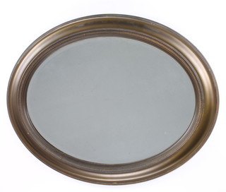 An oval bevelled plate wall mirror contained in a decorative gilt frame 27"h x 33"w 