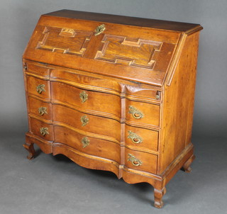 A French oak bureau, the fall front with geometric mouldings, the stepped interior fitted 6 short drawers, the base of serpentine outline fitted 3 long drawers raised on ogee bracket feet 39"h x 40 1/2"w x 18"d