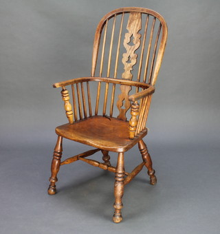A 19th Century elm hoop back Windsor chair with solid seat raised on turned supports with H frame stretcher