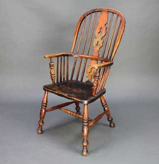 A19th Century elm hoop back stick and rail carver chair with solid elm seat raised on turned supports with H frame stretcher