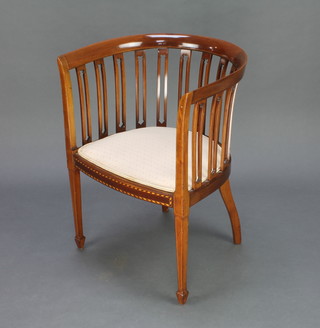 An Edwardian inlaid mahogany tub back chair with upholstered seat raised on square tapering supports 