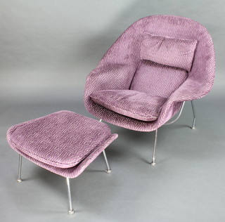 Eero Saarinen (1910-1961), a womb chair and matching ottoman upholstered in purple material and raised on polished chrome supports with steering pad feet 