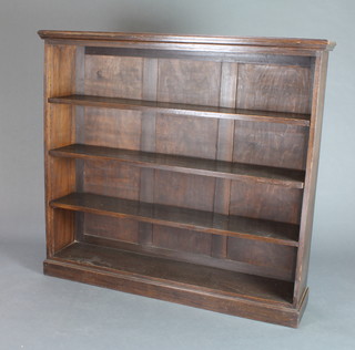 A Victorian oak bookcase with adjustable shelves raised on a platform base 50"h x 54" w x 15"d