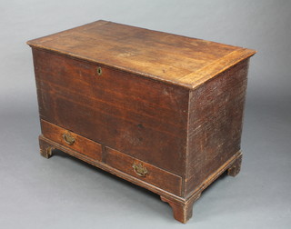 An 18th Century oak mule chest with iron lock and brass escutcheon, the base fitted 2 short drawers and raised on bracket feet 25"h x 37"w x 21"d