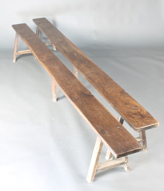 A pair of 18th Century oak trestle benches raised on trestle supports 16 1/2"h x 112"l x 7 1/2"