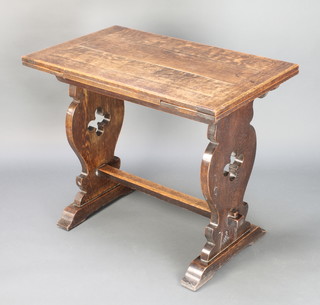 An oak draw leaf dining table the top formed of 4 planks, raised on pierced standard end supports with an H framed stretcher 30"h x 22 1/2"w x 36" x 53 when extended