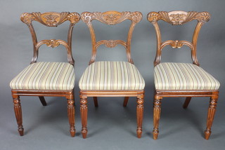 A set of 3 William IV carved mahogany bar back chairs with shaped mid-rails overstuffed seats raised on turned and reeded supports