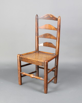 An 18th Century oak ladder back chair with solid seat raised on turned supports