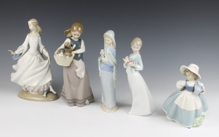 A Lladro figure of a standing girl with lilies, the base impressed 465 43 cm (damaged), a Lladro figure of Cinderella 4328 25cm (fingers f) and  1 other of standing girl with basket of puppies M21E 20cm (f and r) and 2 Nao figures of a standing girl with lidded urn 17cm and a girl with heart shaped trinket box 23cm 