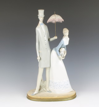 A Nao figure group of standing a gentleman and lady 49cm (ladies fingers f and a foot is chipped) 