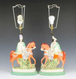 A pair of 19th Century Staffordshire flat back figures of mounted highlanders, converted for use as table lamps 49cm 