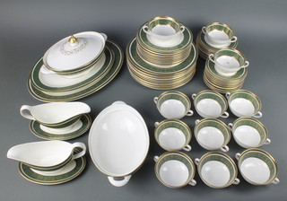 A 65 piece Royal Doulton Vanborough dinner service comprising 2 vegetable tureens -1 with cover, 2 oval meat plates 42cm and 34cm, 2 sauce boats and stands, 12 dinner plates 27cm (some contact marks), 12 side plates 20cm (some contact marks), 12  tea plates 17cm, 12 twin handled soup bowls and 11 saucers (1 cracked)