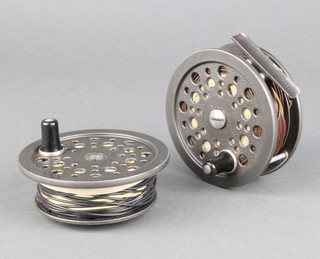 A Condex spool trout fishing reel together with a spare spool 