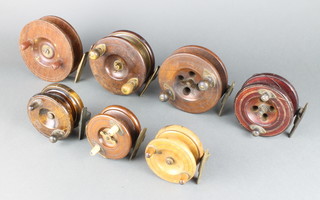A Sun wooden and brass star back centre pin fishing reel 13cm and 6 other wooden centre pin fishing reels 