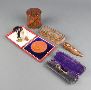 A Tartan Ware - The Medlock rolled tape casket 6.5 x 5.5cm diam., a Victorian novelty wooden snuff box in the form of a shoe 2 x 7 x 1.5cm, a rectangular carved wooden stamp box the lid marked Arosa 2 x 9 x 3.5cm, a Victorian 1897 bronze Jubilee medallion, 2 metal seals and a pair of pince nez 
