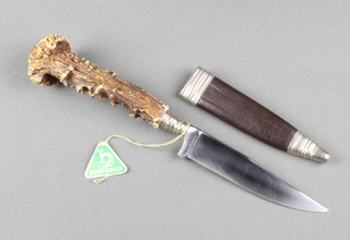 A German mid 20th Century Solinger hunting knife, the 10cm blade marked C.Jul.Herbertz with stag horn grip contained in a leather scabbard