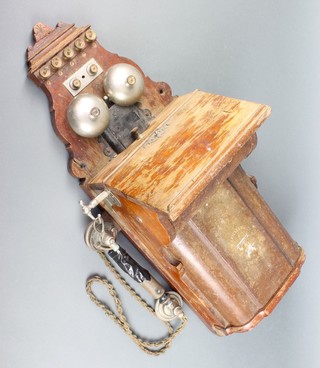 L M Ericsson & Co. of Stockholm, a 19th/20th Century wall mounted wind up telephone contained in mahogany case ringing on two bells  