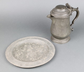 A pewter quart baluster shaped jug marked H & S London 18cm (spreading foot is slightly misshapen), a circular pewter plate 26cm (misshapen and corroded)