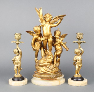 A 19th Century gilt painted cherub sculpture representing The Arts, raised on a white circular socle marble base 40cm together with a similar pair of gilt painted candlesticks in the form of cherubs supporting sconces 28cm h (possibly made up) 