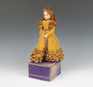 A porcelain automaton in the form of a Victorian standing girl, the head incised RT Ells 