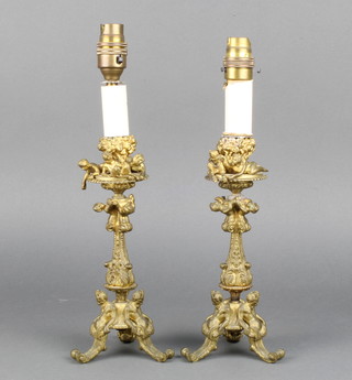 A pair of gilt metal table lamps decorated reclining cherubs 25cm 