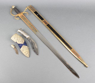 An "El Sid" style sword, the blade marked Toledo contained in a plush scabbard (damaged) together with a Kukri with white metal mounts