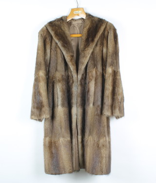 A lady's full length brown fur coat 