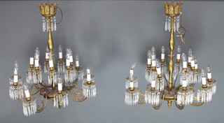 A handsome pair of 16 branch gilt metal electroliers with candle sconces 40cm h x 29cm diam. 