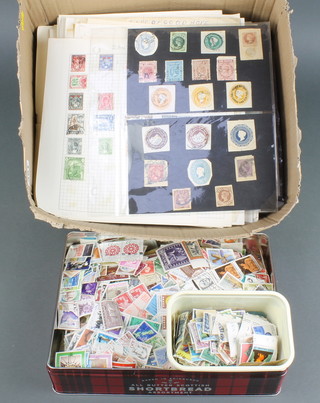 A collection of loose sheets of mint and used world stamps together with a mint and used world stamps