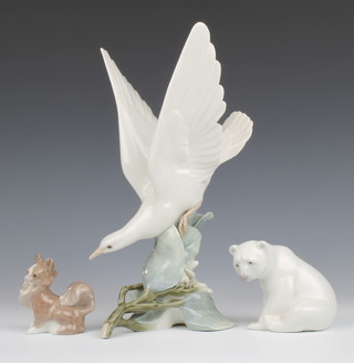 A Lladro figure of a dove 28cm, do. polar bear 8cm and do. figure of a seated dog 7.5cm (chip to ear) 