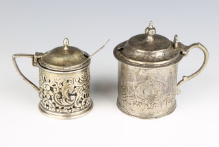 A Victorian engraved silver mustard pot London 1854 complete with blue glass liner together with an Edwardian pierced silver mustard pot Birmingham 1901, 172 grams 
