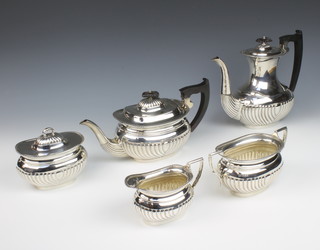 A five piece silver tea/coffee service with demi-reeded decoration, comprising tea pot, coffee pot, cream jug, twin handled sugar bowl and lidded caddy, Sheffield 1941 by Viner's Ltd, 2466 grams