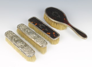 A silver and tortoiseshell  clothes brush and hairbrush, Birmingham 123, and 2 other brushes